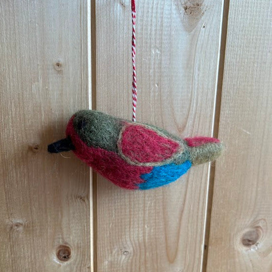 Colorful bird-shaped toy hanging on a wooden wall