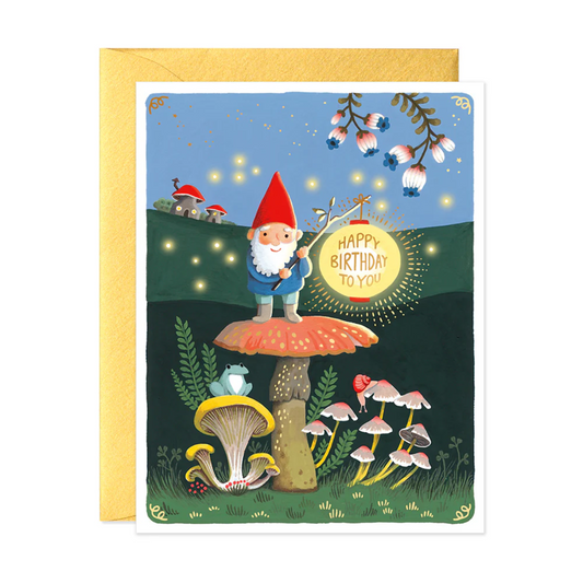 A hand illustrated greeting card with a gnome character, mushrooms, and a birthday message, featuring gold and neon details on a yellow background.
