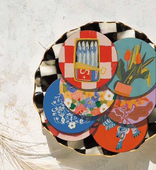 Set of colorful ceramic coasters with various designs on a textured surface.